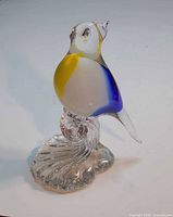 full view of art glass bird on base