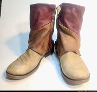 front view of leather boots showing multicolor panels and side zips