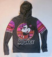 Front view showing Mickey graphic, striped sleeves, hood, drawstrings