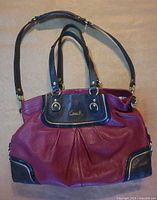 Front view showing burgundy body, brown trim, handles, and crossbody strap