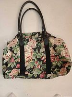 Front view of floral canvas gym bag showing pattern, handles and straps