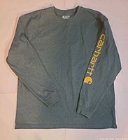 Front view of Carhartt long sleeve shirt showing logo on sleeve