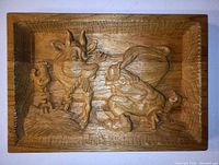 Full front view of rectangular oak relief carving with farm scene