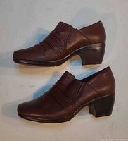 Left and right side view of both boots showing leather, heel height and condition