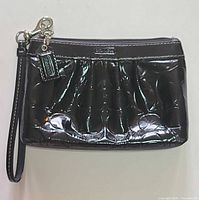 Front view of Coach patent leather wristlet