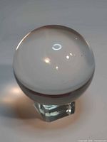 Side view of crystal sphere on cube stand