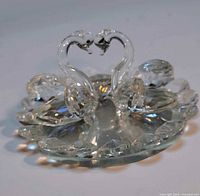 front angled view of twin swan crystal ornament on faceted base