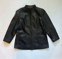 Front view of navy leather jacket laid flat showing overall condition