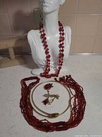 Group view of all jewellery items on display bust and countertop