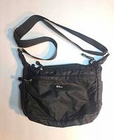 Front view showing logo, strap, front pocket