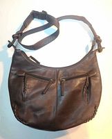 Front view showing overall shape, strap and two front zip pockets