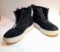 Pair of boots angled view showing front zippers and soles