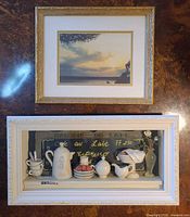Two framed artworks: upper sunset cloud print, lower Ruskamp diorama