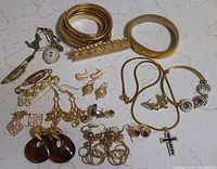 All items laid out including belt, brooches, necklaces, earrings