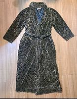 Full view of robe laid flat showing length, belt, pattern, pockets