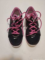 top view of both shoes showing black mesh, pink laces and lining, white swoosh on toe
