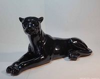 full view of reclining black panther sculpture, front and side