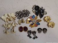 Group shot of all seven pairs of clip earrings laid out