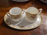 Sugar bowl and creamer on matching tray