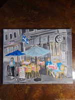 Full view of signed café scene painting