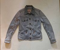 Front view of light blue-grey Parasuco jacket showing buttons, pockets, zippers