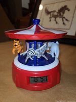 Front view showing carousel animals and LCD display