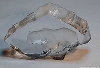 Front view of clear glass paperweight showing bear relief inside