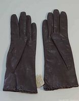 pair of dark brown kid leather gloves front view
