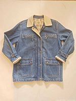 Front view of denim chore jacket with corduroy collar and pockets visible