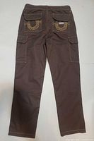 Back view of brown cargo pants showing embroidered flap pockets