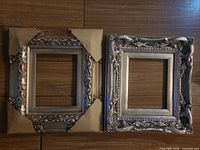 Front view of both ornate silvertone wooden frames with corner protectors
