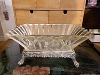 Side view of glass centerpiece on silver-plated stand