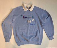 Front view of light blue Lee sweatshirt with Alaska dog sled embroidery
