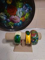 All three hand-painted bangles displayed on stand