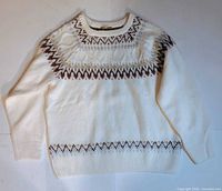 Front view of cream sweater with patterned yoke