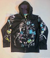 Front view showing embroidery, zip, hood