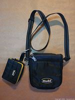 Full view of Mudd nylon crossbody bag beside matching wallet