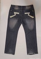 Back view showing lightning bolt appliques and overall wash