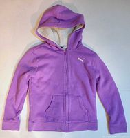 Front view of purple Puma hoodie with logo and pockets