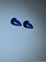 Two pear-cut deep blue tanzanites face-up view