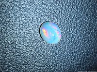 Front view of oval cabochon opal showing play-of-colour