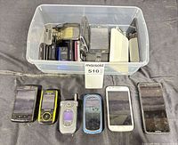 Overview of all phones, six displayed front and remainder in plastic bin