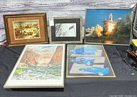 Overview showing all five framed artworks laid out on table