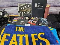Group shot of Beatles books, magazines, DVDs, towel, mug and vinyl