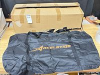 Closed shipping carton and one Aceletiqs bag displayed