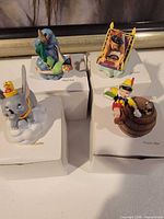 Four Disney Magic thimbles displayed on individual boxes
