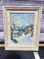 Framed oil on board winter village scene in wood frame