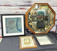Octagonal mirror and three framed prints displayed on table