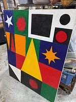 Full view of framed abstract geometric painting with vivid shapes and colours