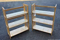 Front view of both wooden shelves showing four tiers and slatted sides